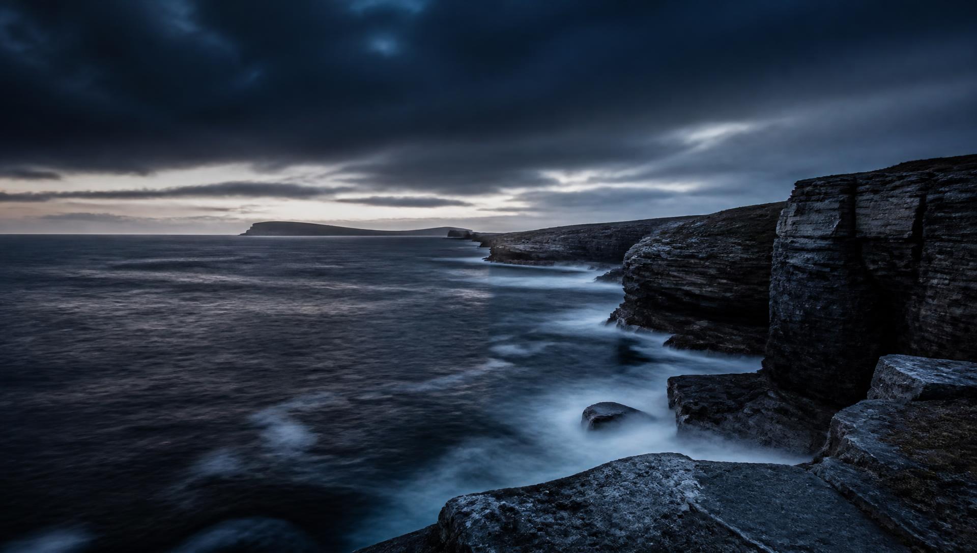 Dark northern coastline at first light